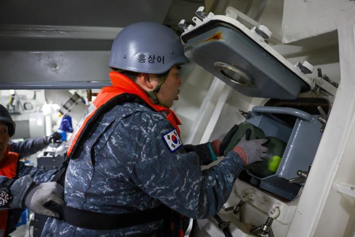 ROKS Pohang sailors fire a small depth charge at 9