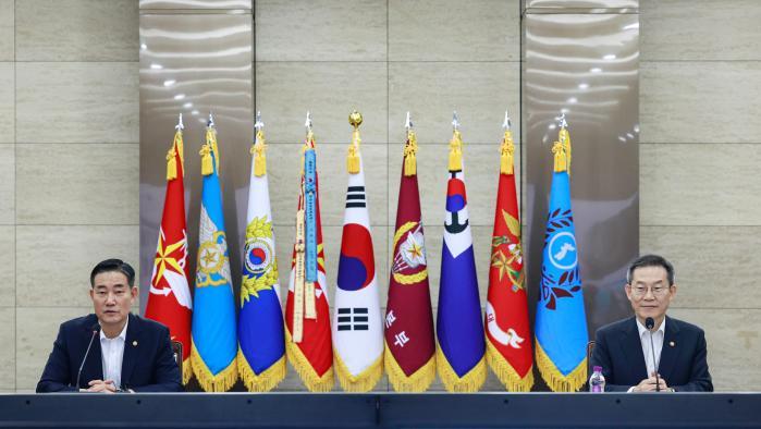 Defense Minister Shin Won Sik (left) makes his ope