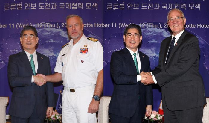 Defense Minister Kim Yong Hyun shakes hands with N