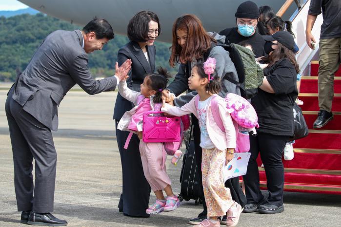 Vice Defense Minister Kim Seon Ho (left) touches a