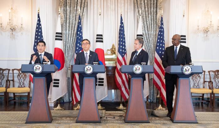 Defense Minister Kim Yong Hyun (far left) speaks a