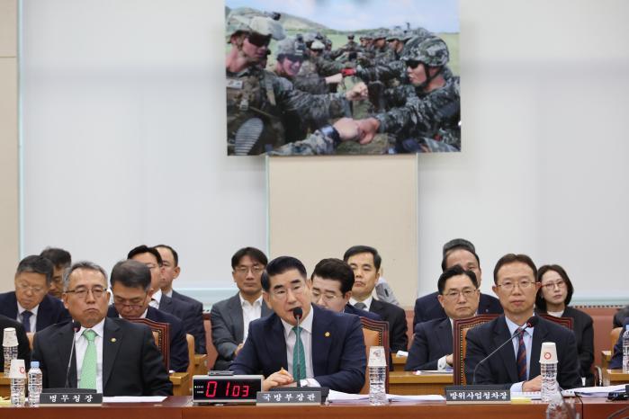 Defense Minister Kim Yong Hyun (center) responds t